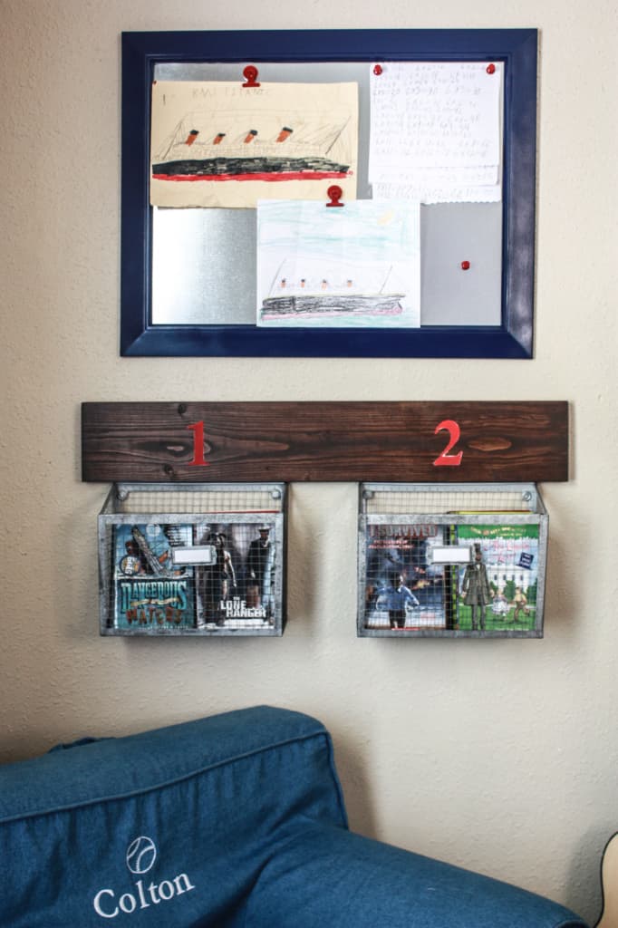 Wall baskets for storage hanging above a chair with a magnetic message board above the baskets