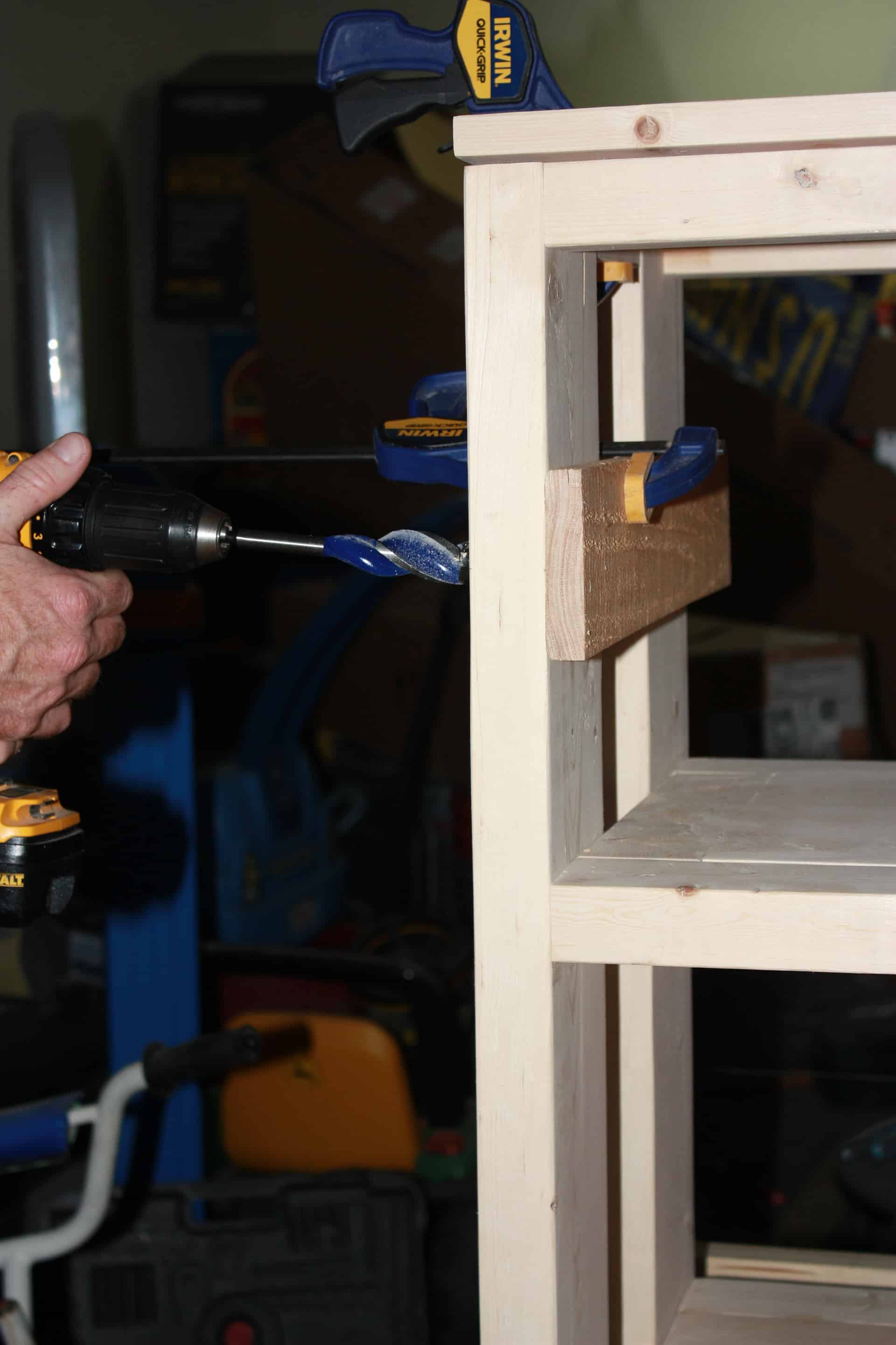 drilling the holes on the console table for the steel pipe