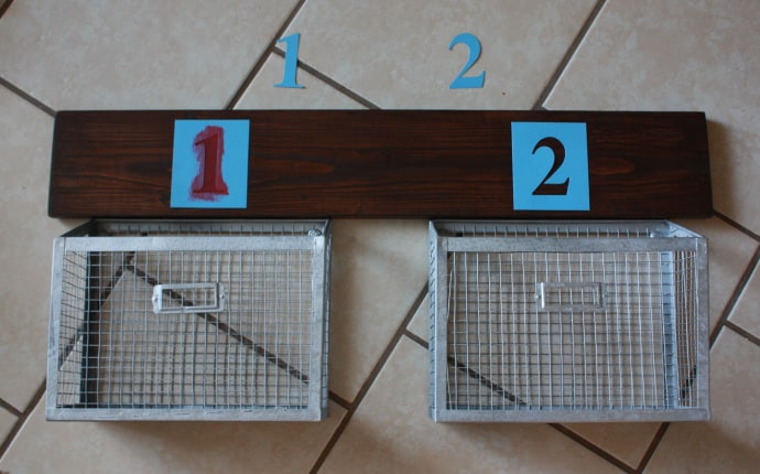 Stenciling the numbers on the wall hanging baskets