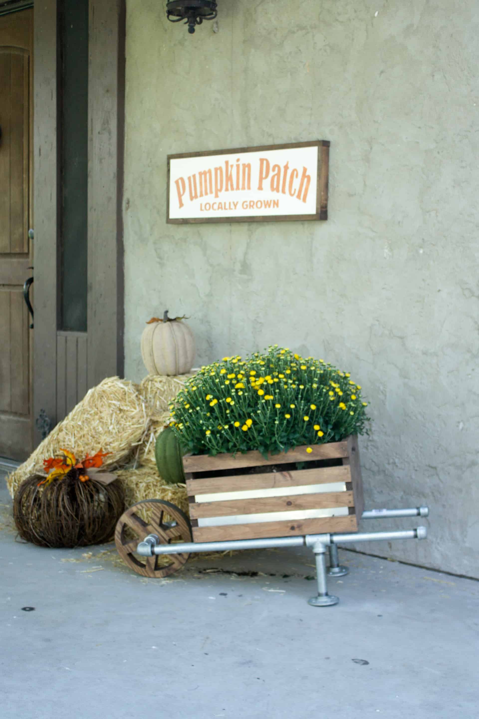 DIY wheelbarrow made of galvanized pipe and a wooden crate