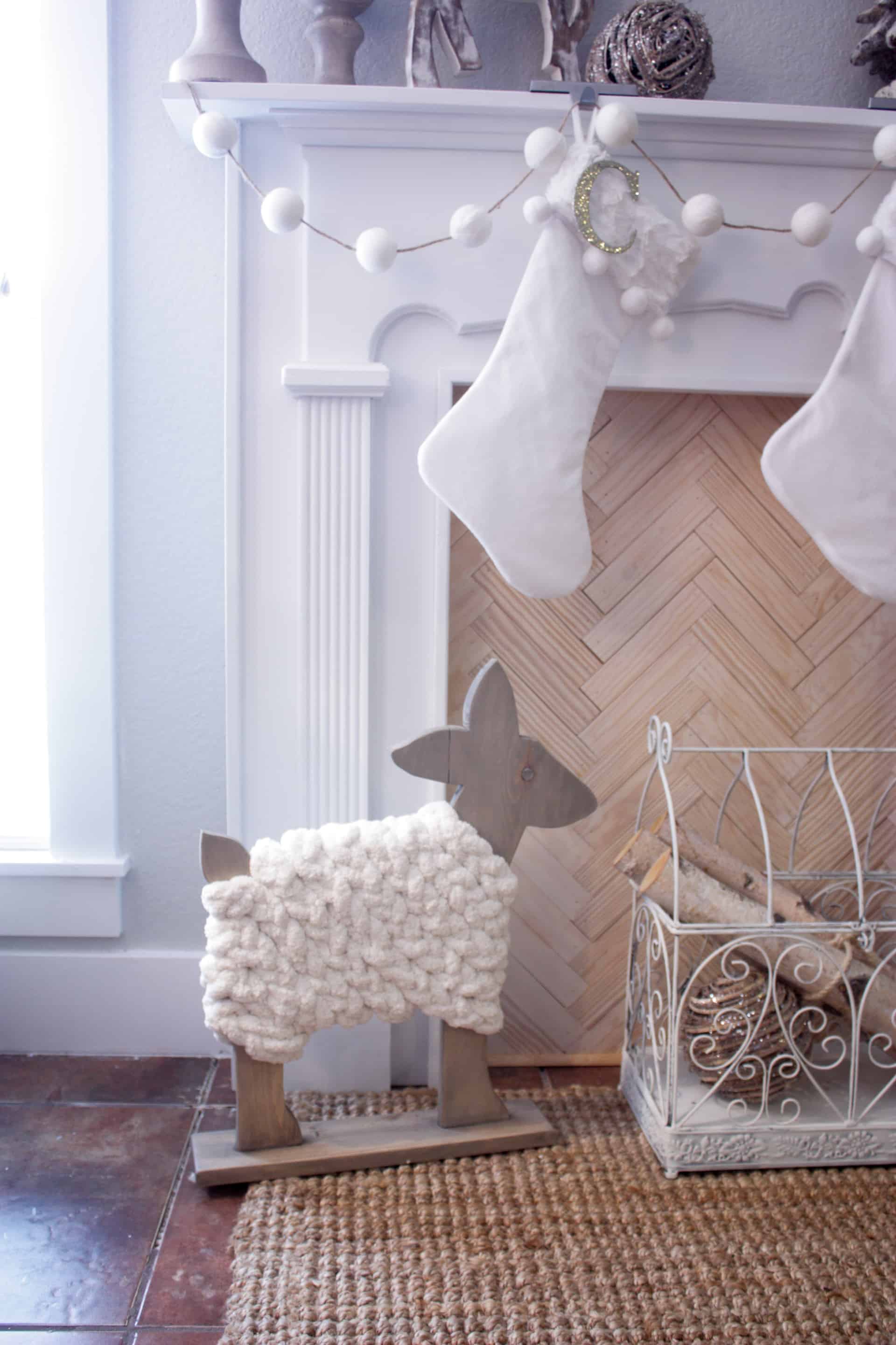 DIY wood deer decor sitting by the fireplace with stockings hanging