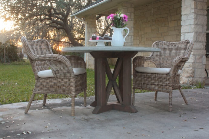 DIY Wood Pedestal Table Base with X accents on patio with two chairs