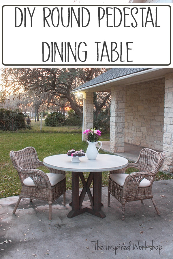 round concrete top dining table with two wicker chairs and some cupcakes sitting on the table with a pitcher of flowers