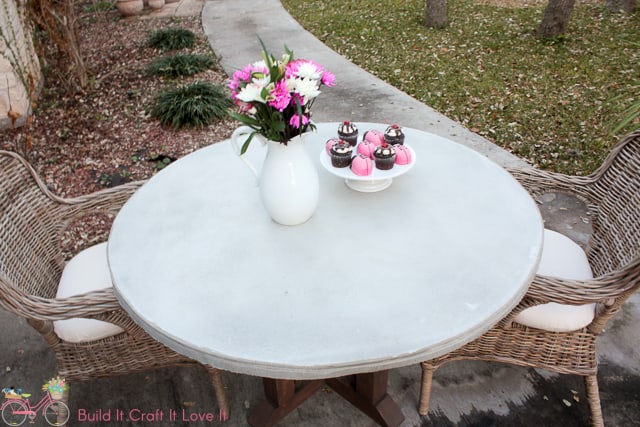 Round Concrete Table Top up close with white pitcher and desserts on the table