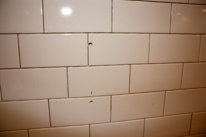 showing the holes in the tile for the vent hood to be attached to the wall