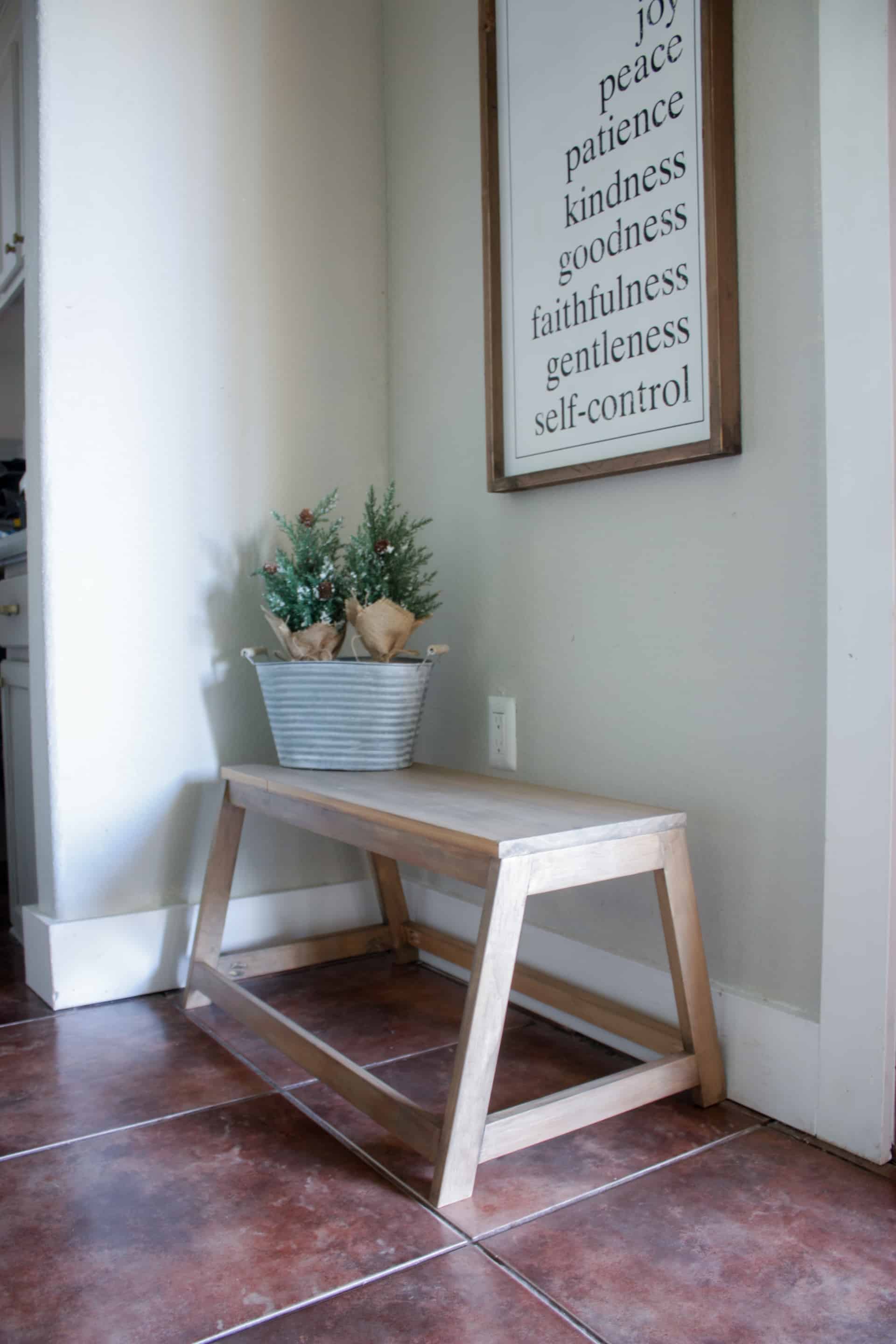 DIY Small Modern Bench in entry way with small galvanized bucket and winter trees along with a fruits of the spirit sign hanging above it