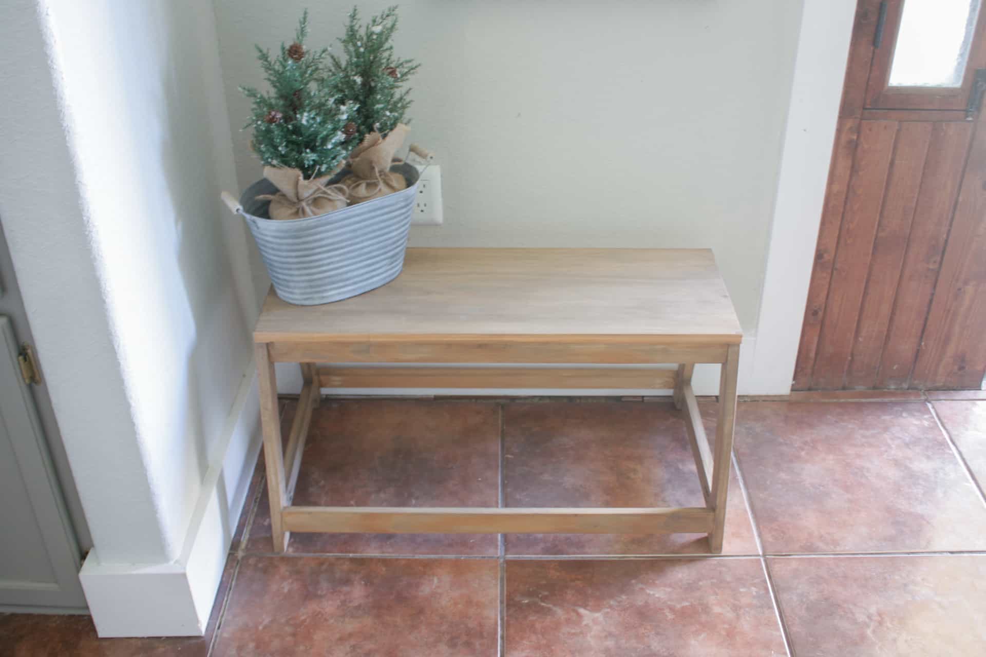 Joanna Gaines Bench with small christmas trees sitting on it