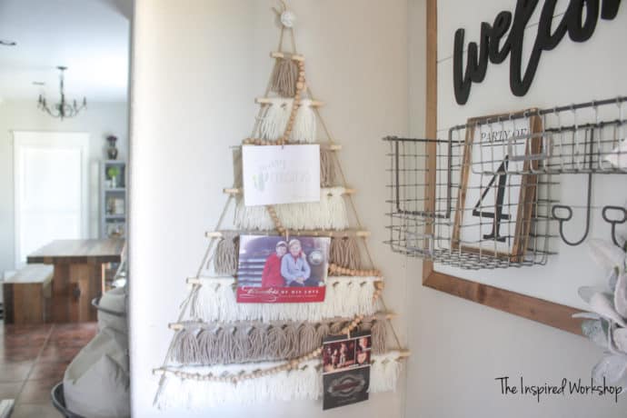 DIY Tassel Tree Christmas Card Holder - Tree made of tassels in cream and gray yarn with christmas cards displayed