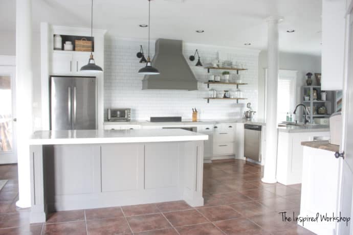 DIY Kitchen Renovation Reveal - In this Diy kitchen renovation I was able to do all the work calling in the back up of my hubby a few times! This old brown kitchen is now a beautiful white and gray kitchen complete with subway tile and open shelves! The vent hood anchors the large wall! I will share how I poured the kitchen countertops, painted the cabinets, built the vent hood, built out the island and so much more!