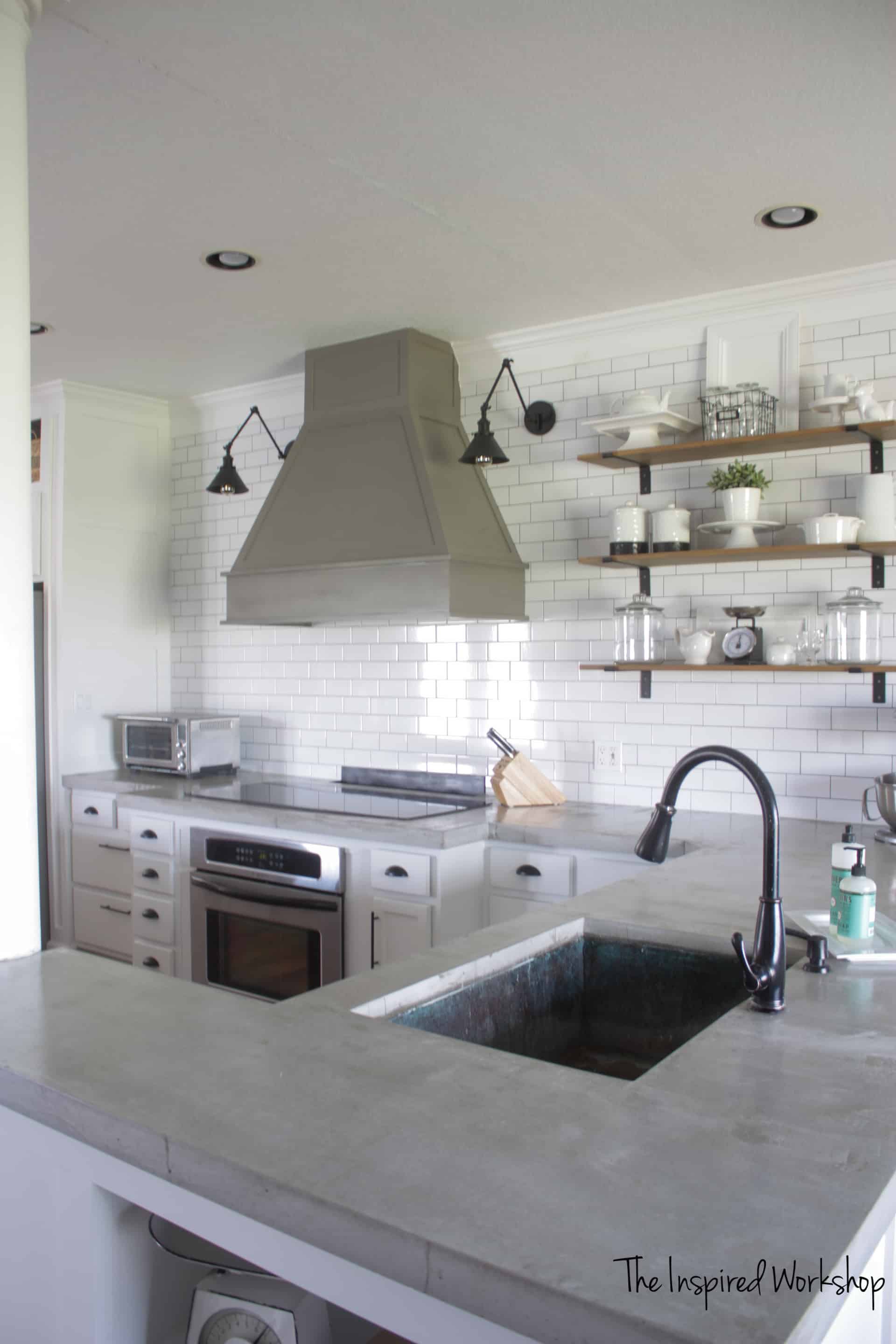 Kitchen with white subway tile and concrete countertops