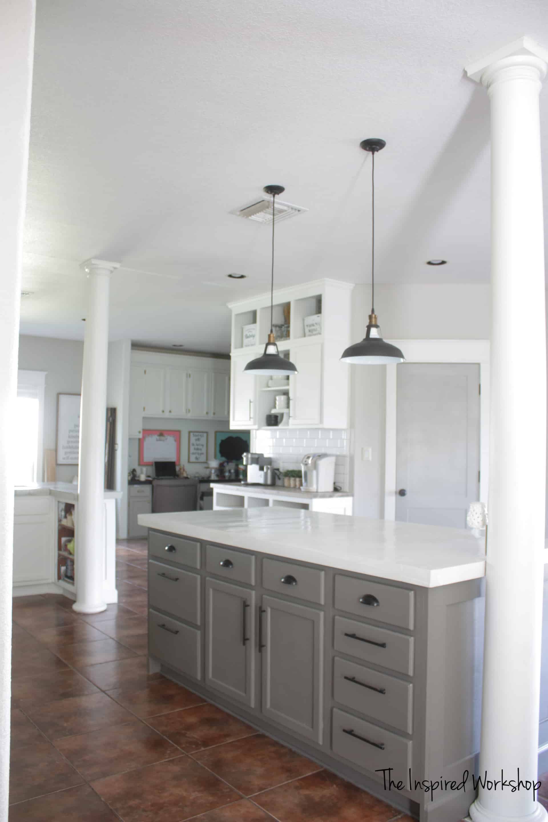 DIY Kitchen Renovation - Kitchen remodel completed on a budget and og beautiful white and gray cabinets along with subway tile and swing arm lampS!