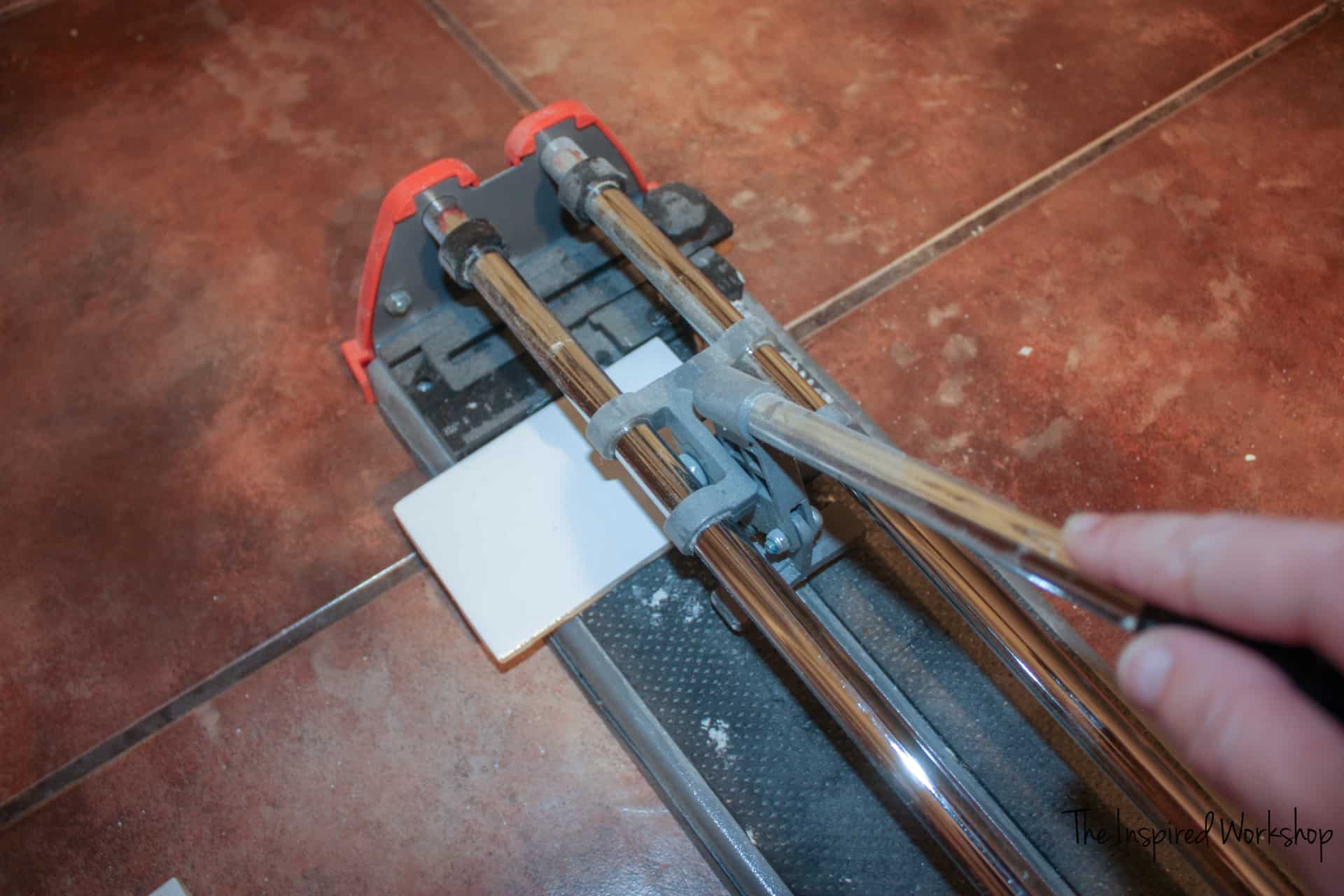 Using a tile cutter to make cuts in subway tile