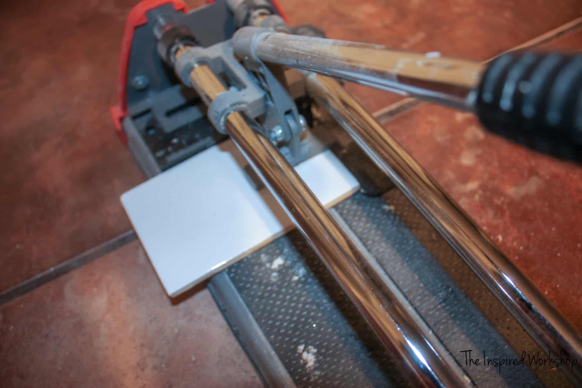 Using a tile cutter to cut tile