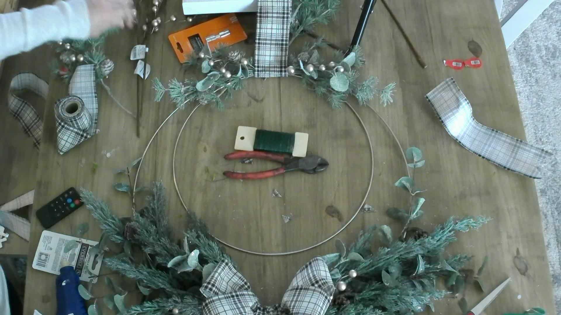 Adding the gold balls to the Christmas wreath