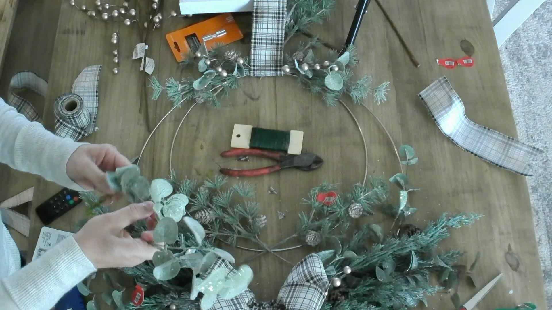 Laying out the second layer on the DIY Christmas Wreath