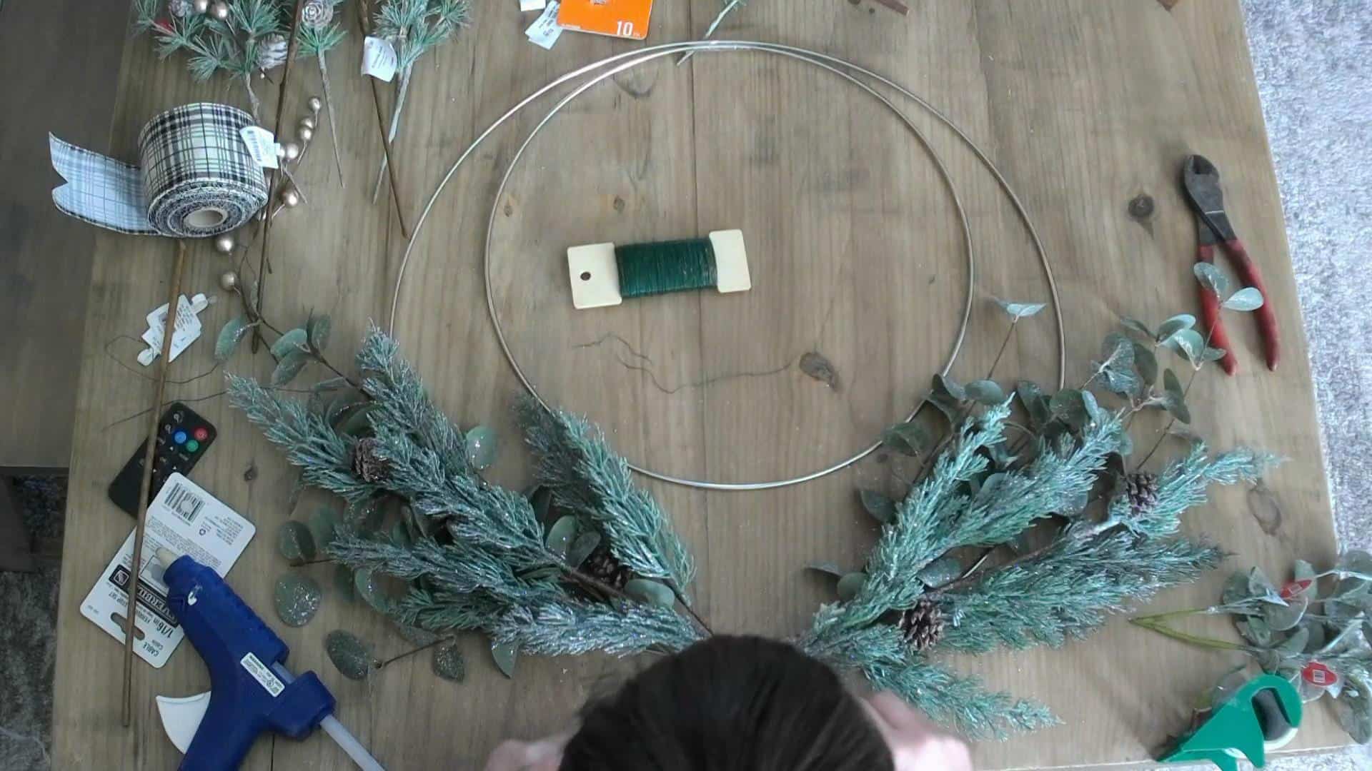 Adding Eucalyptus and pine to the christmas wreath