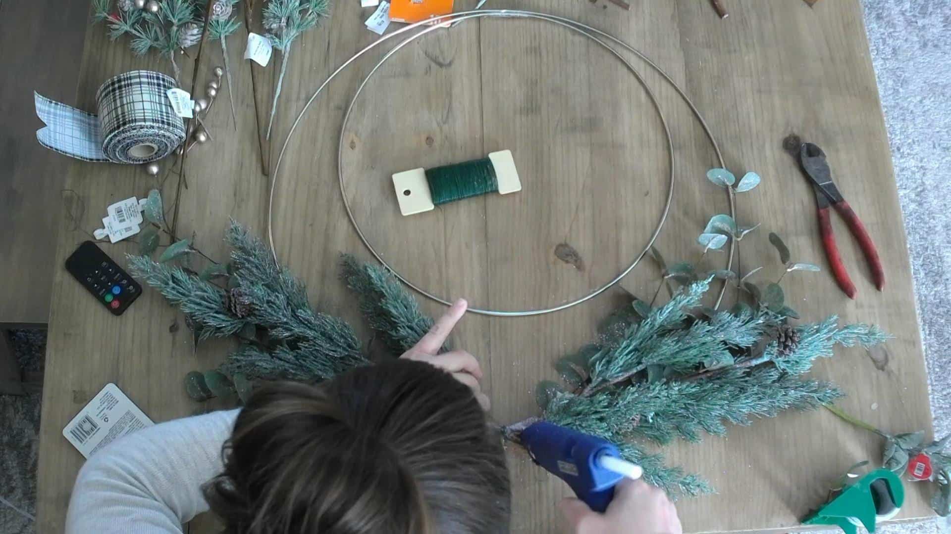 Hot gluing the DIY christmas wreath