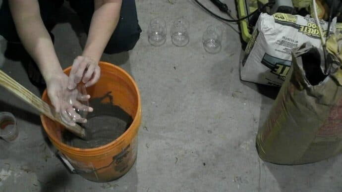 Showing the plasic wine glass I poured the concrete into to make the gnome body