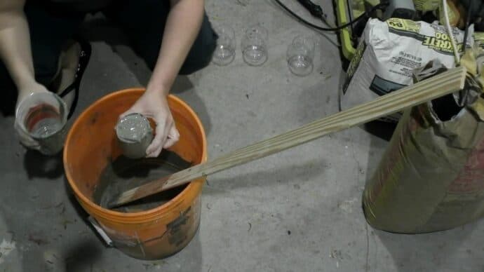 filling the wine glasses with concrete for the gnome bodies