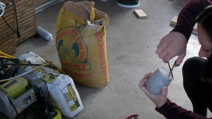 Taking the concrete out of the wine glasses after they have cured