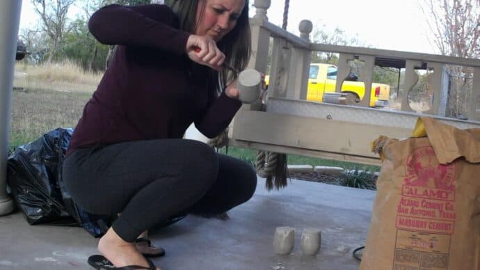 Removing the concrete form the wine glasses after it has cured