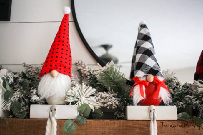 Gnome stocking holders made with concrete bodies to hold stocking on the fireplace mantel