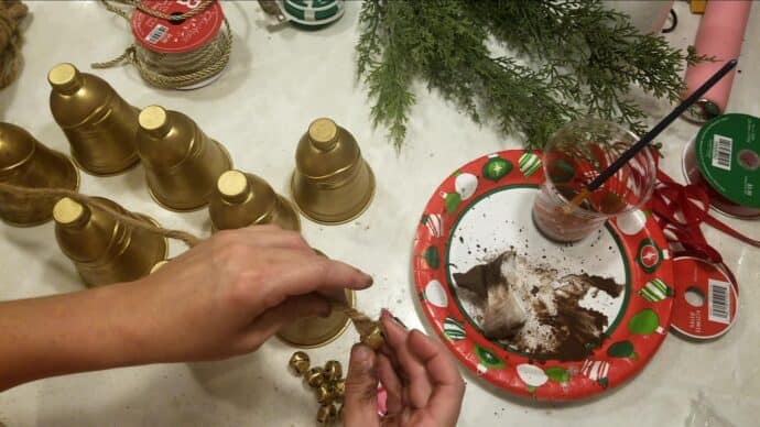 Adding the jingle bell to the inside of the brass bells