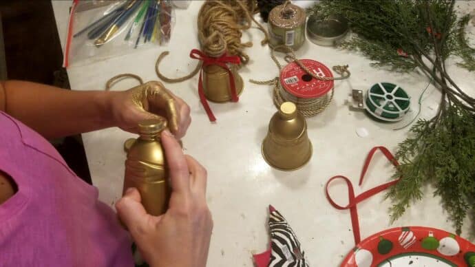 adding the twine to the neck of the bell to hang
