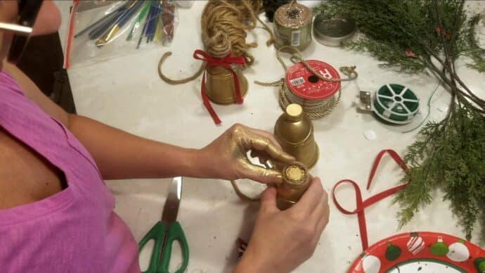 wrapping the rope around the top of the bell to hang