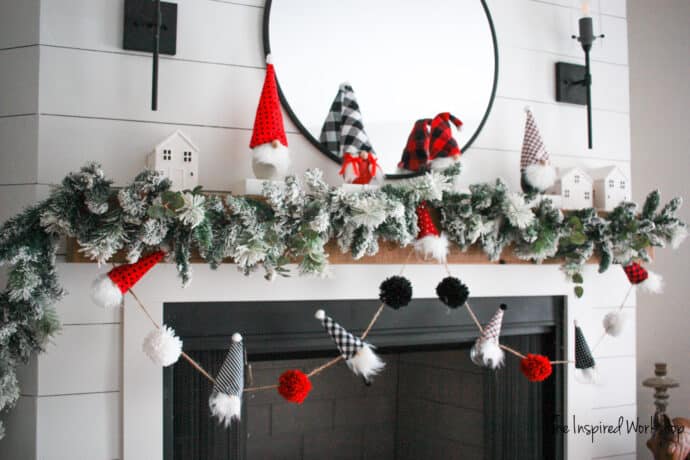 DIY Christmas Garland with Gnomes strung below the mantel with a red and black theme