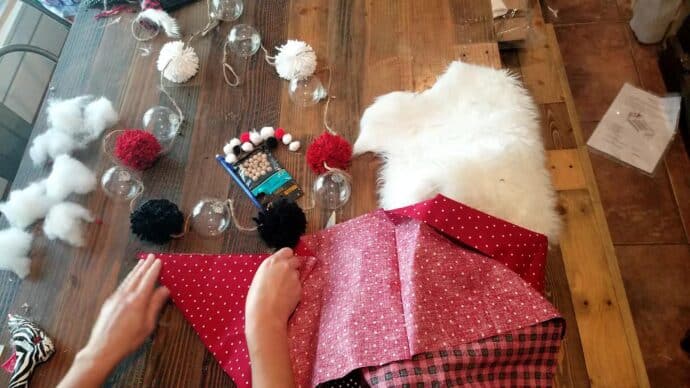 Cutting the fabric for the gnome's hat on the garland