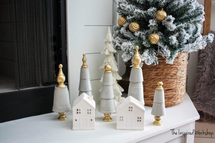 Concrete cone christmas trees along with little white ceramic houses