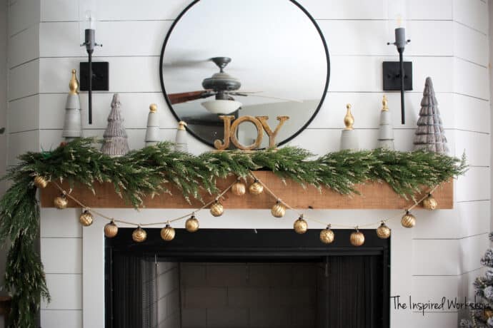 DIY Christmas Trees made with concrete and wood finials on the fireplace mantel