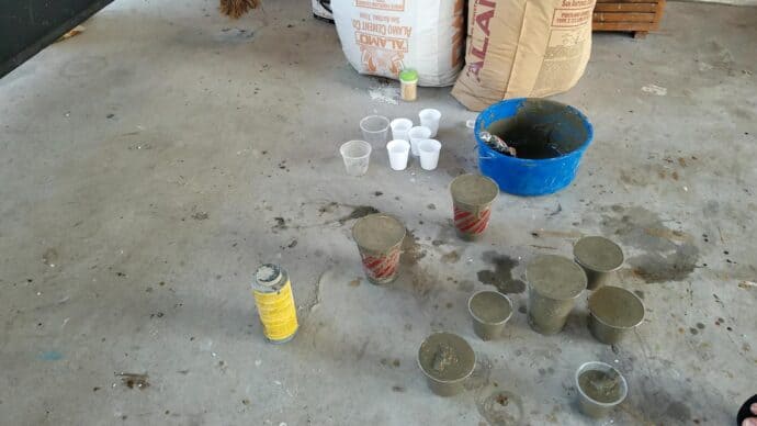 Getting all the cups filled with cement for the concrete christmas trees