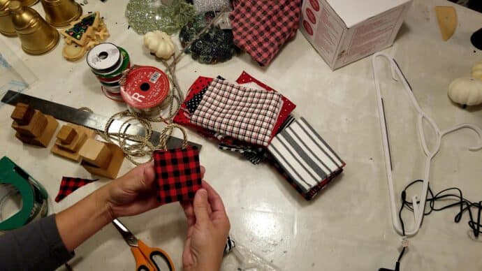 gluing the handles on the gift bag christmas ornament