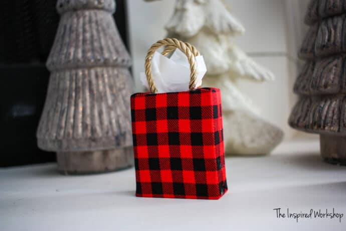 DIY Gift Bag ornament made from scrap wood covered in black and red fabric