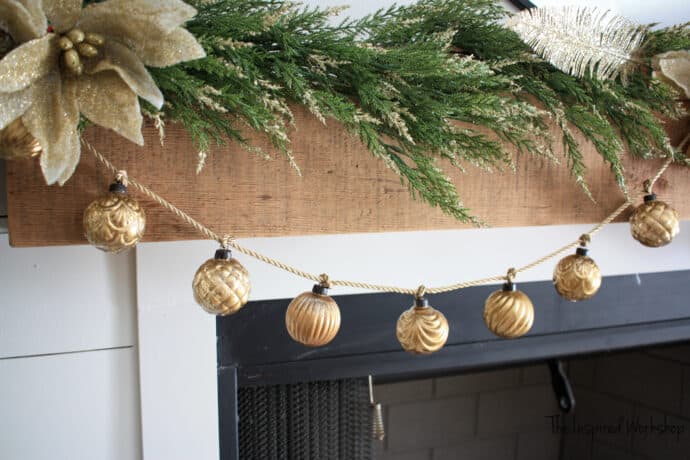 DIY Mercury glass ornaments strung on a gold rope to make a garland for the fireplace