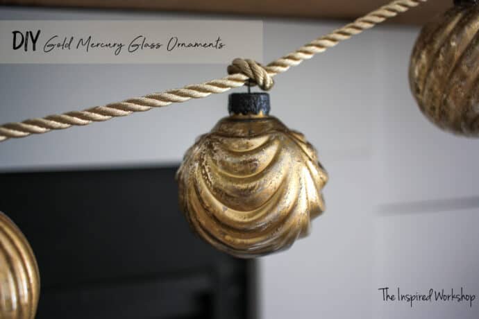 DIY Gold Mercury Glass Ornaments turned into a garland for the fireplace and hung on a gold rope ribbon