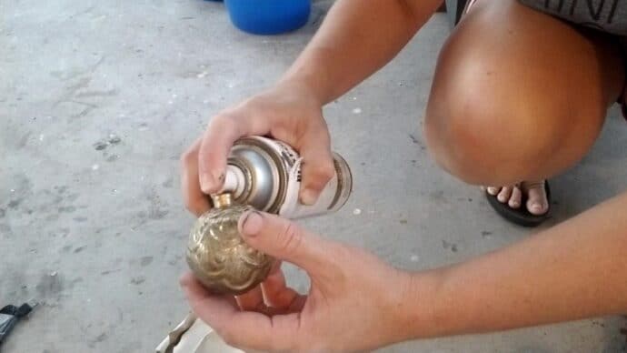 adding more gold spray paint to the ornament to make the diy mercury glass ornaments