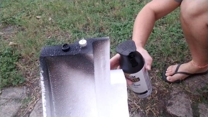 sticking the ornament caps into styrofoam so I can spray paint them for the mercury glass ornaments