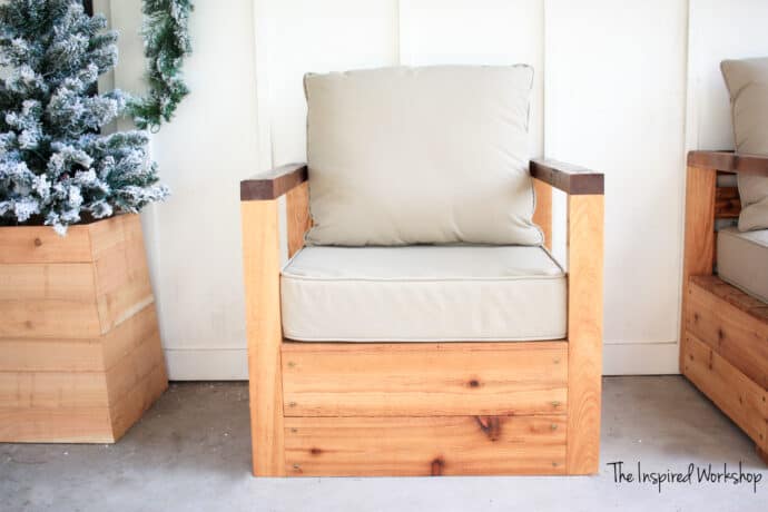 DIY Outdoor Patio Chair with tan cushions and a tree in planter with white wall