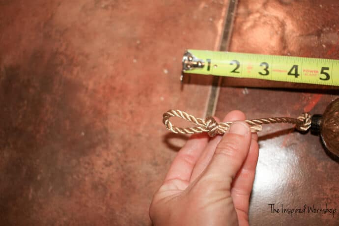 Tying the loop knot in the ribbon to make a garland for the mercury glass ornaments