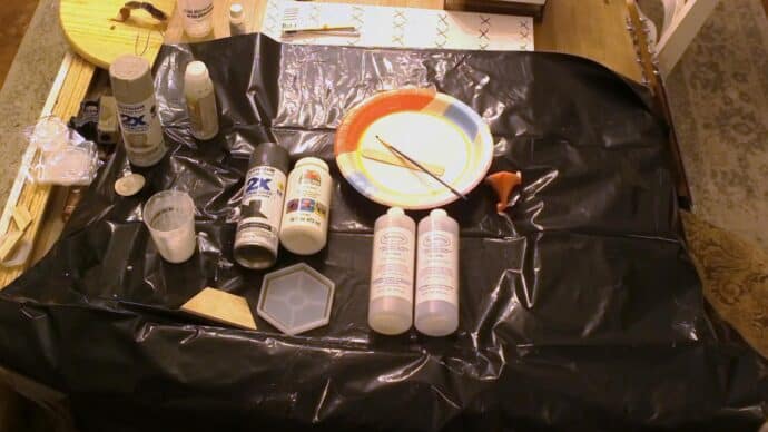 materials all gathered to make the coasters - epoxy resin, mold, paint, paper plate and paint brush