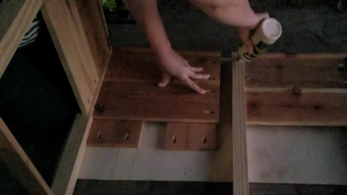 Putting glue on the side frame of the DIY planter boxes