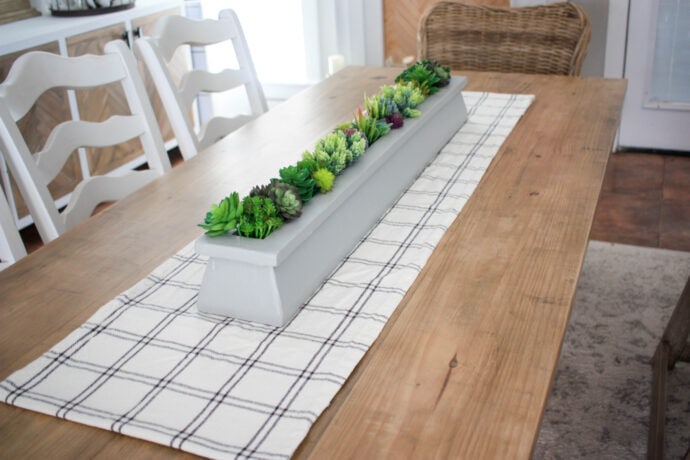 succulent planter as table centerpiece with black and white plaid table runner