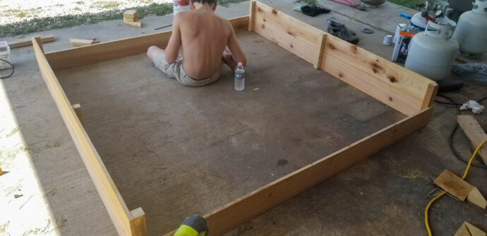 attaching the two planter box walls to each other forming a box