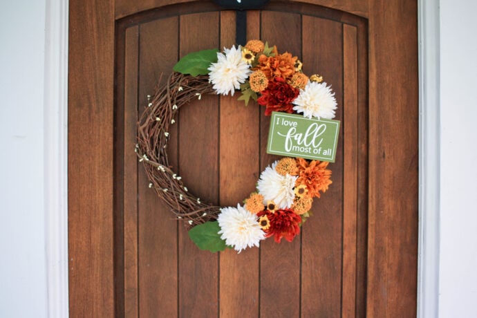 Fall grapevine wreath hanging on wood door