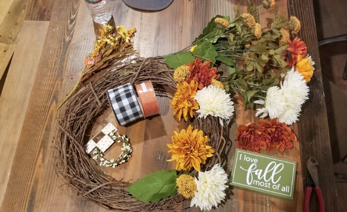 supplies needed to make the fall grapevine wreath - floral bunches, ribbon, grapevine wreath form, i love fall sign