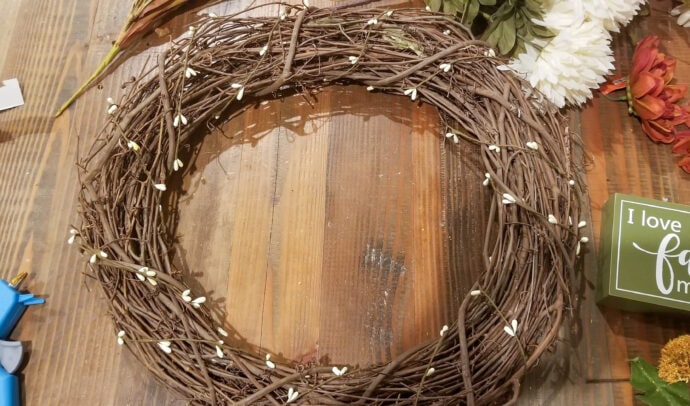 the grapevine wreath form with the small white bead garland wrapped around it