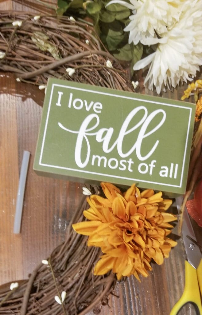 adding chrysanthemums to the fall wreath